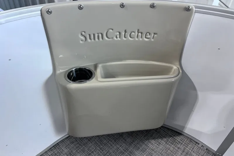 Slide: The Image of 2026 SunCatcher Select 18F boat interior with cup holder and storage compartment. - 29