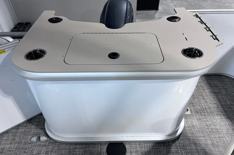Slide: The Image of 2026 SunCatcher Select 18F boat console with cup holders and storage compartment. - 20