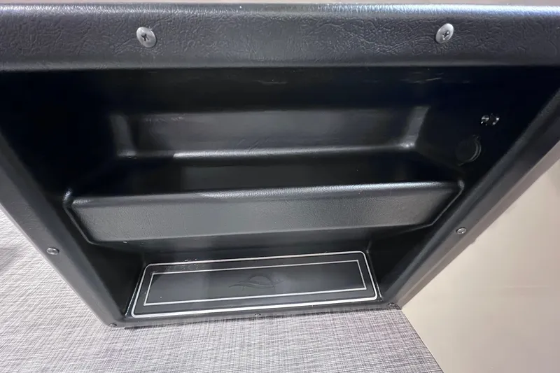 Slide: The Image of Interior storage compartment of 2026 SunCatcher Select 18F boat, featuring sleek black design. - 16
