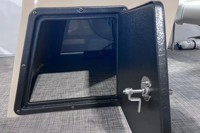 Slide: The Image of Open storage compartment on 2026 SunCatcher Select 18F boat, featuring secure latch mechanism. - 19