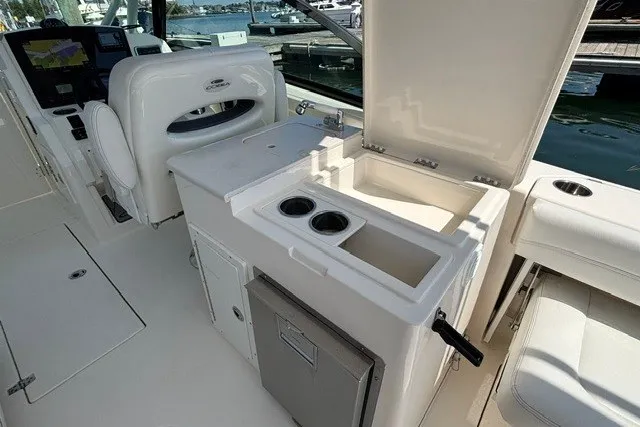 Slide: The Image of 2022 Cobia 280 Dual Console boat interior with seating, storage, and control panel. - 14