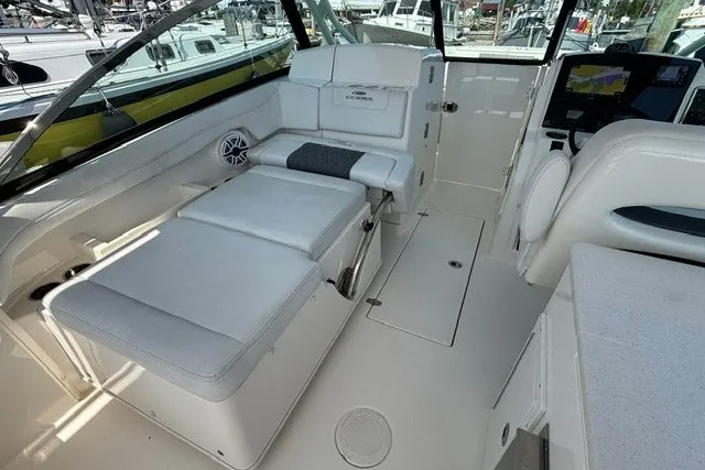 Slide: The Image of 2022 Cobia 280 Dual Console interior with white seating and modern dashboard. - 22
