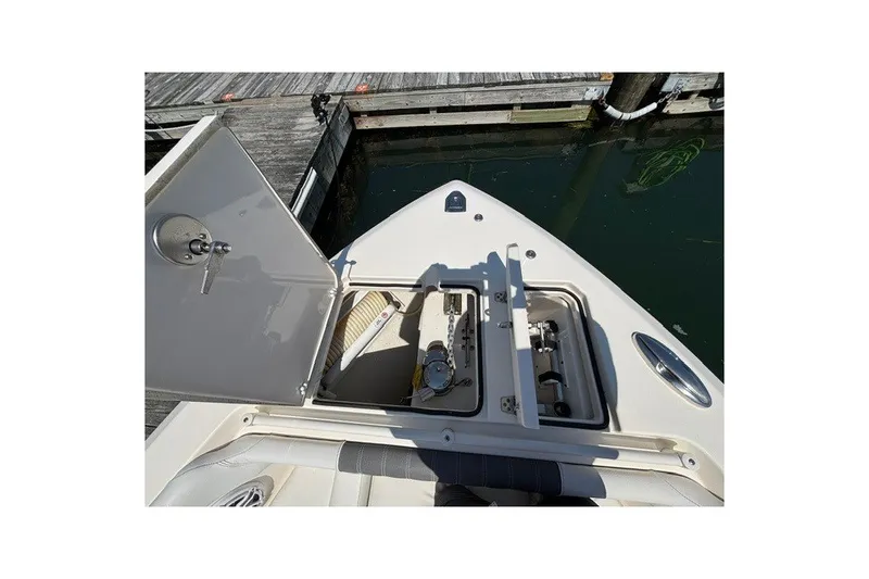 Slide: The Image of Open anchor compartment on 2022 Cobia 280 Dual Console boat at dock. - 6