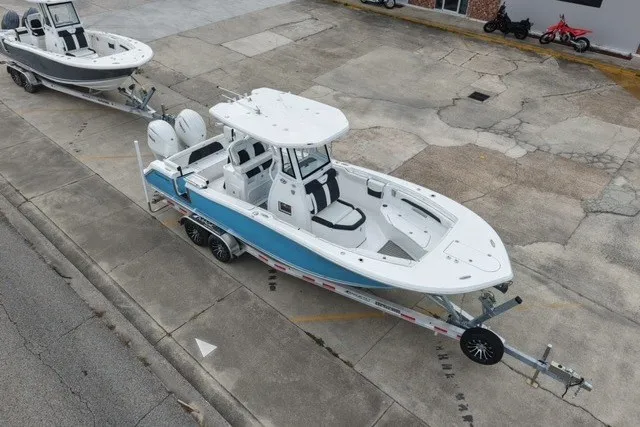 Slide: The Image of 2026 Tidewater 272 LXF boat on trailer, parked outdoors, showcasing sleek design and modern features. - 3
