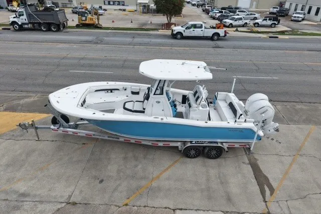 Slide: The Image of 2026 Tidewater 272 LXF boat on trailer, parked in urban setting. - 7