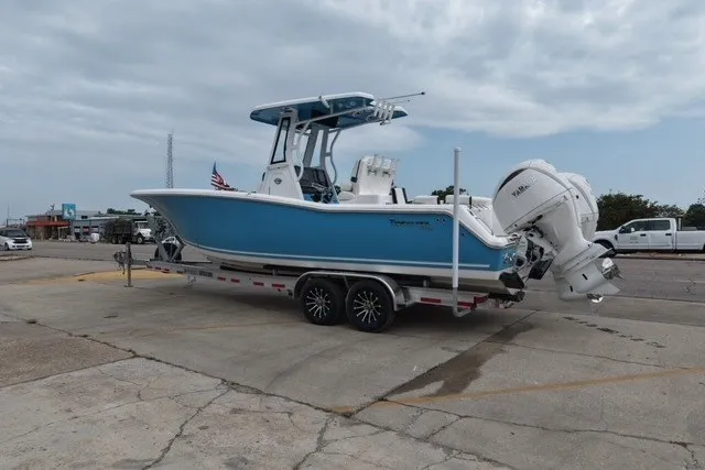 Slide: The Image of 2026 Tidewater 272 LXF boat on trailer, blue hull, parked outdoors. - 1