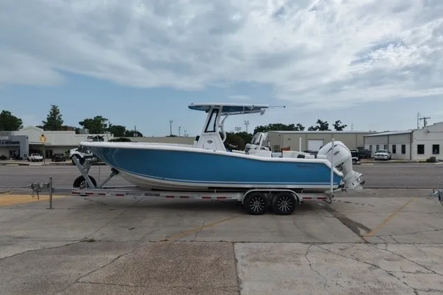 The Image of 2026 Tidewater 272 LXF boat on trailer, parked outdoors under cloudy sky. - 0