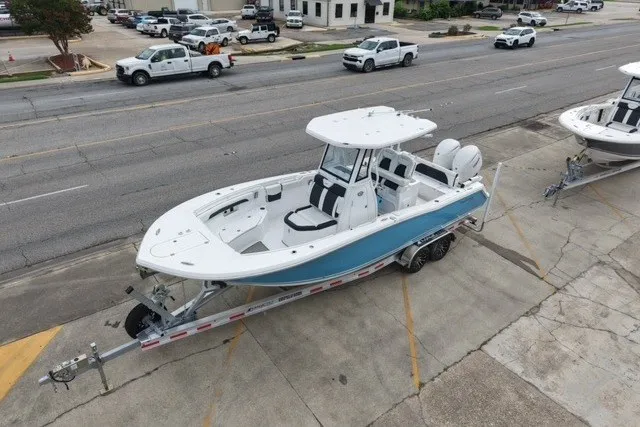 Slide: The Image of 2026 Tidewater 272 LXF boat on trailer, parked on urban street. - 8
