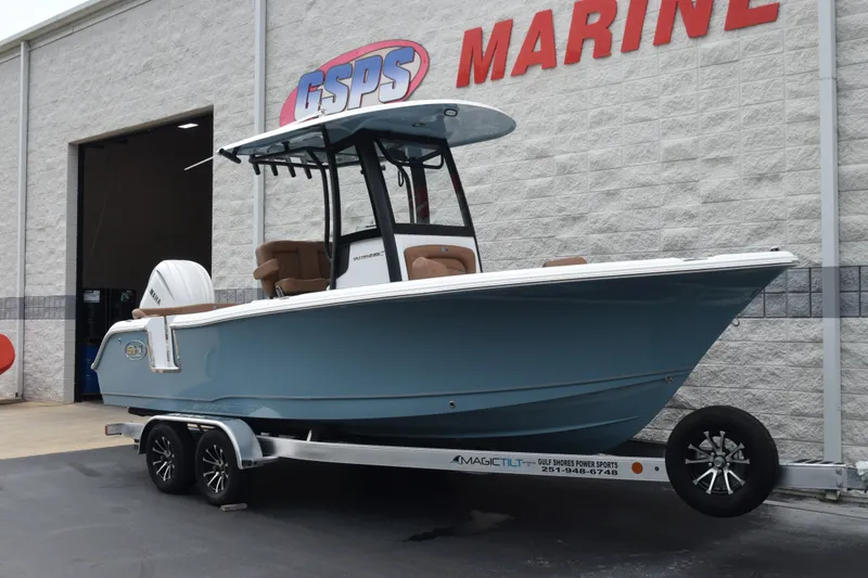 Slide: The Image of 2027 Sea Hunt Ultra 235SE boat on trailer outside GSPS Marine building. - 2