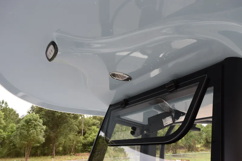 Slide: The Image of 2027 Sea Hunt Ultra 235SE boat roof detail with window and light fixtures. - 15