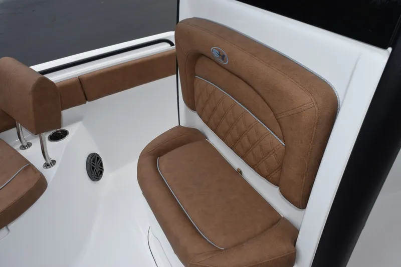 Slide: The Image of 2027 Sea Hunt Ultra 235SE boat interior with brown cushioned seating and sleek design. - 14