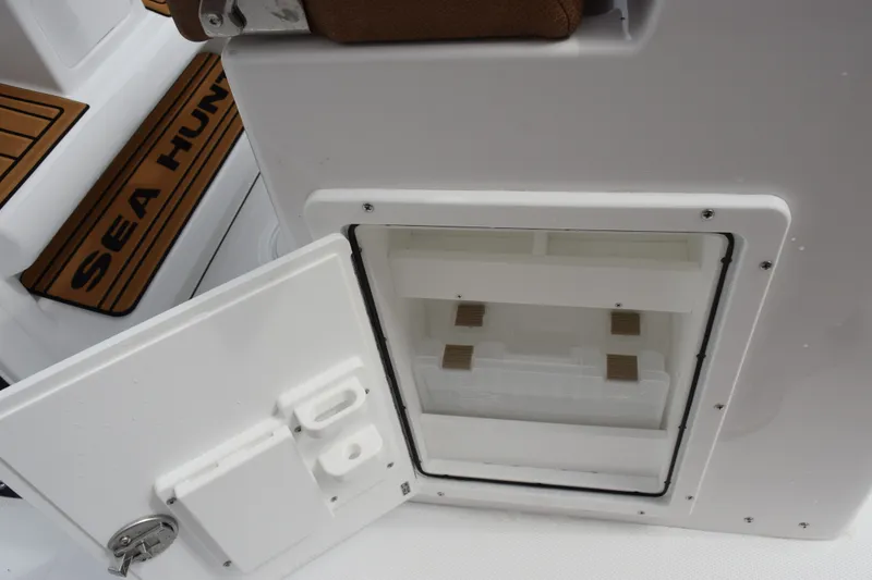 Slide: The Image of Open storage compartment on 2027 Sea Hunt Ultra 235SE boat interior. - 19