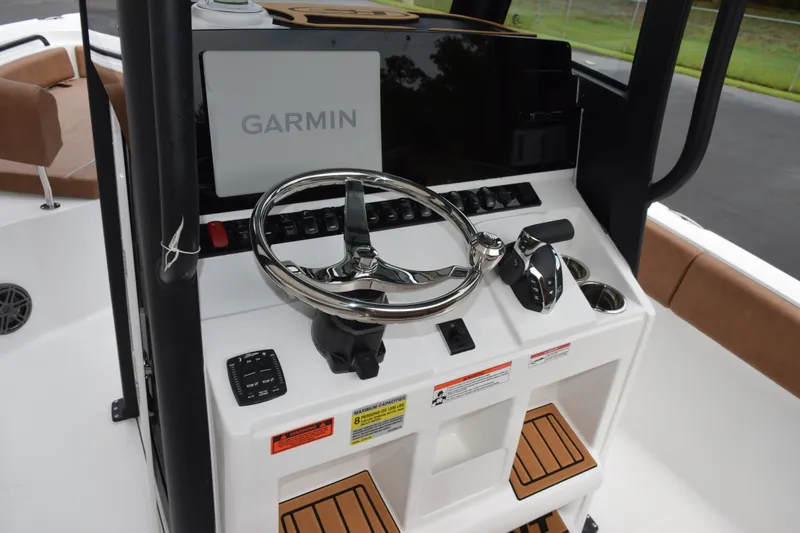 Slide: The Image of 2027 Sea Hunt Ultra 235SE boat console with Garmin navigation and modern controls. - 11