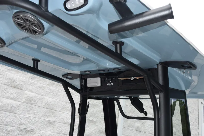 Slide: The Image of 2027 Sea Hunt Ultra 235SE boat T-top with speakers and rod holders. - 8