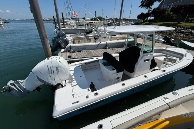 Slide: The Image of 2023 Everglades 253 Center Console boat docked at marina, featuring sleek design and powerful engine. - 3