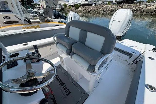 Slide: The Image of 2023 Everglades 253 Center Console boat interior with dual seating and steering wheel. - 10