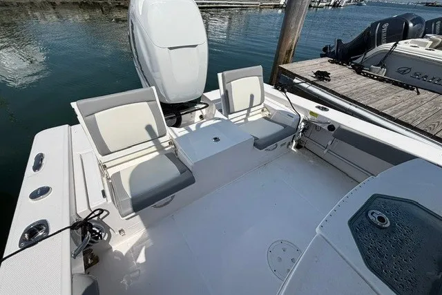 Slide: The Image of 2023 Everglades 253 Center Console boat interior with seating and engine view. - 15