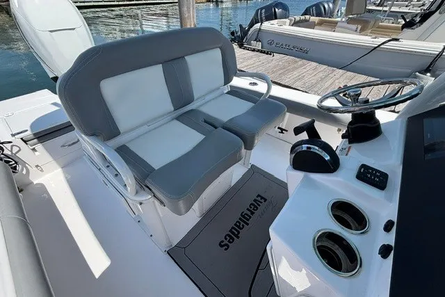 Slide: The Image of 2023 Everglades 253 Center Console boat interior with seating and steering wheel. - 11