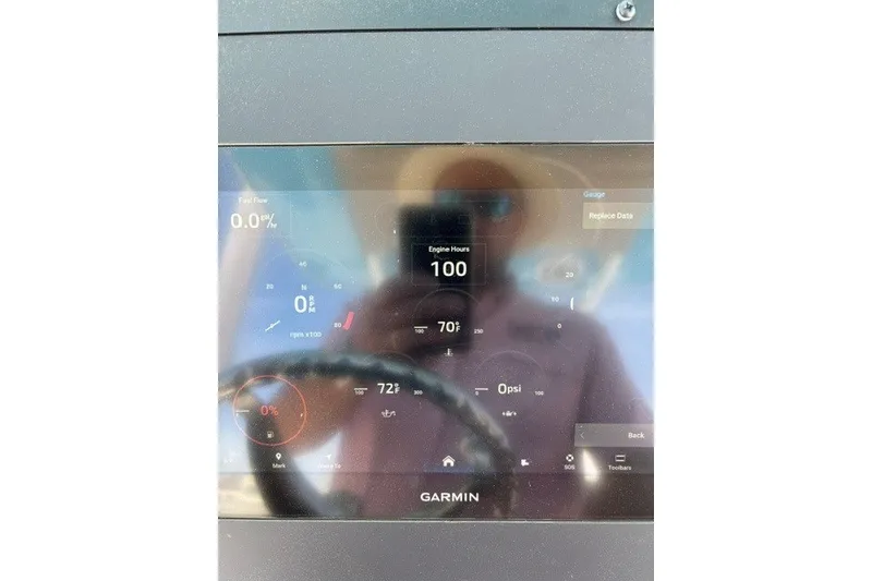 Slide: The Image of Garmin display on 2023 Everglades 253 Center Console showing engine hours and fuel flow. - 9