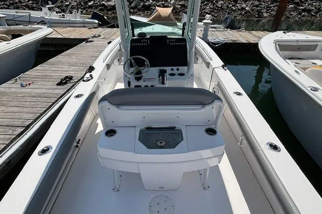 Slide: The Image of 2023 Everglades 253 Center Console boat docked, showcasing helm and seating area. - 14