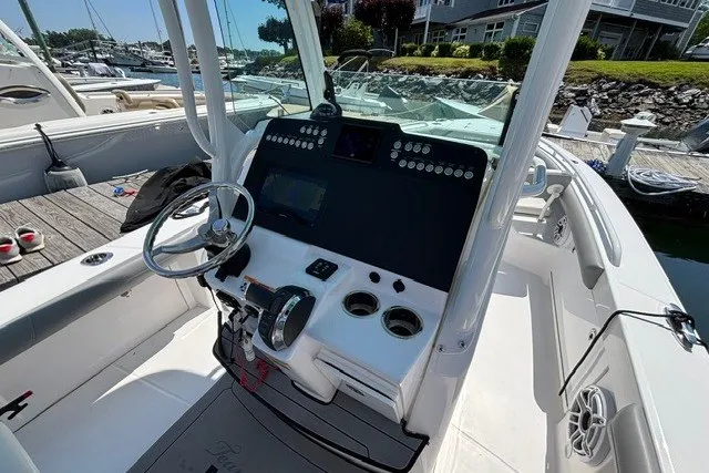 Slide: The Image of 2023 Everglades 253 Center Console boat interior with steering wheel and control panel. - 8