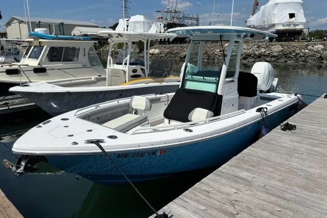 Slide: The Image of 2023 Everglades 253 Center Console boat docked at marina, featuring sleek design and modern amenities. - 1
