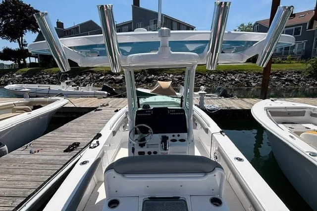 Slide: The Image of 2023 Everglades 253 Center Console boat docked, showcasing helm and seating area. - 13