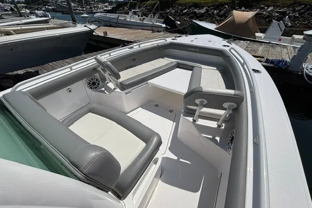 Slide: The Image of 2023 Everglades 253 Center Console boat with spacious seating at a marina dock. - 5