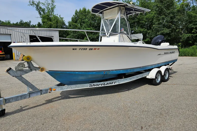 Slide: The Image of 2005 Sea Hunt Triton 232 boat on ShoreLand'r trailer, parked outdoors. - 2