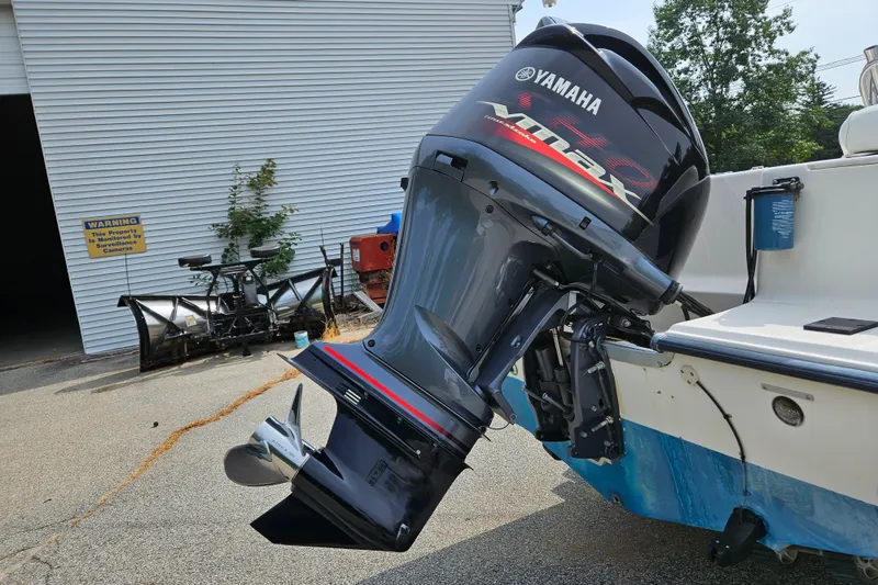 Slide: The Image of 2005 Sea Hunt Triton 232 with Yamaha VMAX outboard motor in a marina setting. - 4