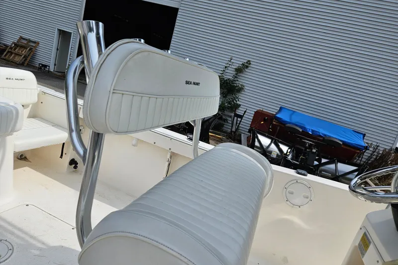 Slide: The Image of 2005 Sea Hunt Triton 232 boat interior with white seating and stainless steel accents. - 10
