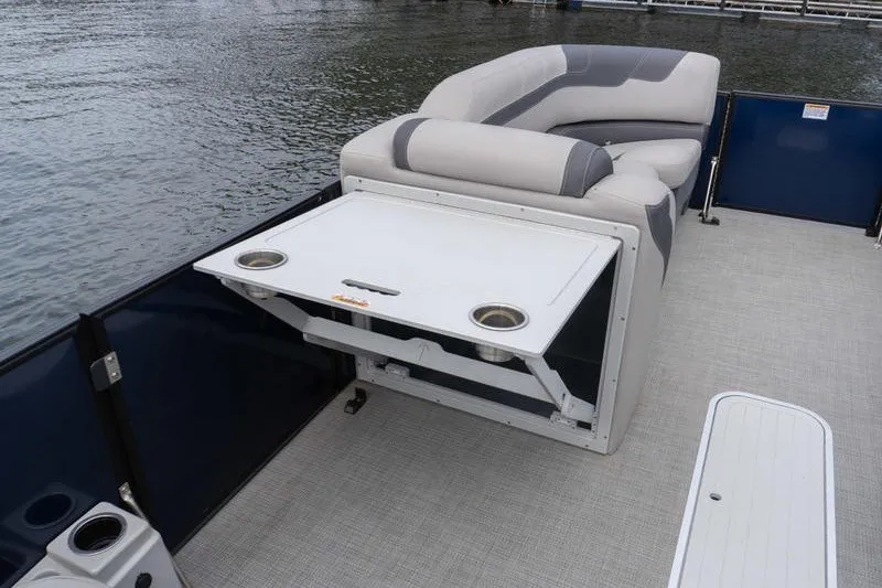 Slide: The Image of 2024 Sylvan L5 DLZ pontoon boat with foldable table and cushioned seating. - 15