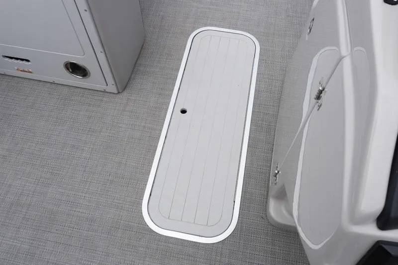 Slide: The Image of 2024 Sylvan L5 DLZ boat interior with storage compartment on textured flooring. - 16