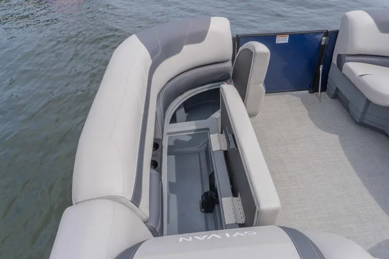 Slide: The Image of 2024 Sylvan L5 DLZ boat interior with spacious seating and storage on water. - 20