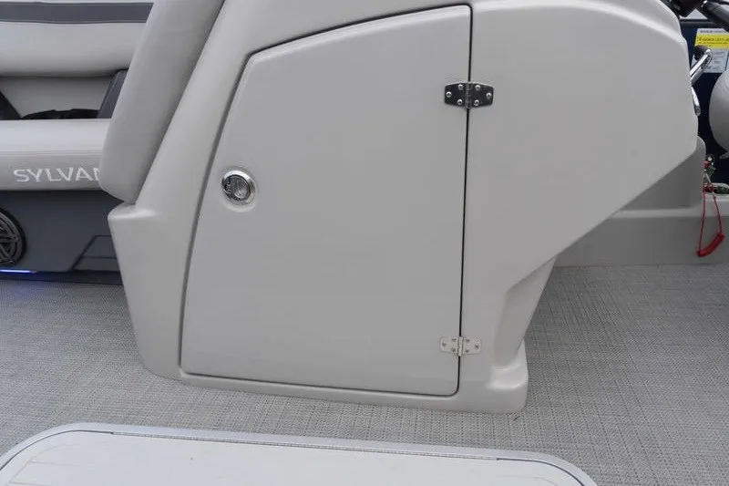Slide: The Image of 2024 Sylvan L5 DLZ boat interior with storage compartment and seating. - 12