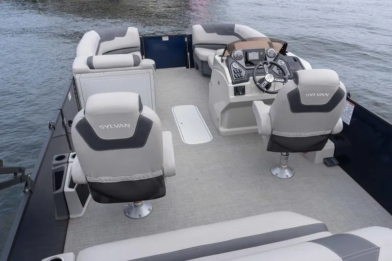 Slide: The Image of 2024 Sylvan L5 DLZ pontoon boat interior with plush seating and modern helm. - 8