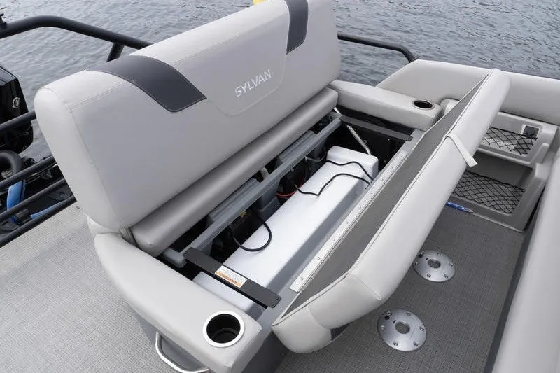 Slide: The Image of 2024 Sylvan L5 DLZ boat seat storage compartment with cup holders and gray upholstery. - 27