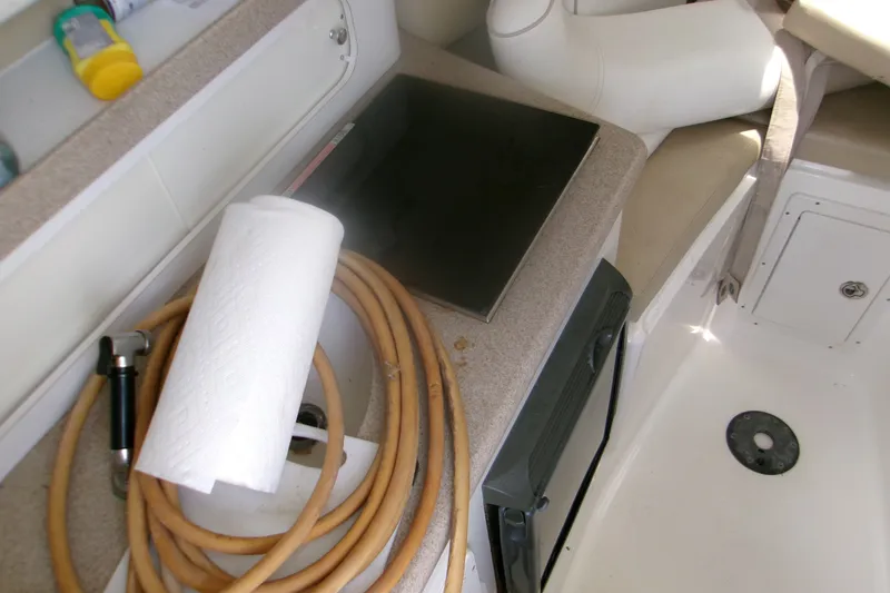 Slide: The Image of Interior of a 2007 Century 2400 Walk-Around boat with hose and paper towel. - 7