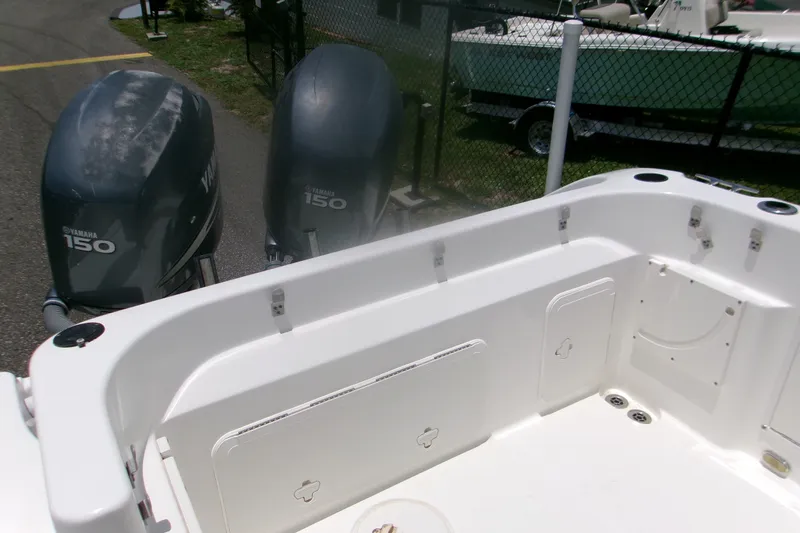 Slide: The Image of 2007 Century 2400 Walk-Around boat with twin Yamaha 150 engines, docked outdoors. - 15