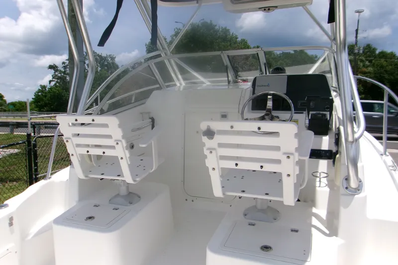 Slide: The Image of 2007 Century 2400 Walk-Around boat interior with helm and seating under clear skies. - 5