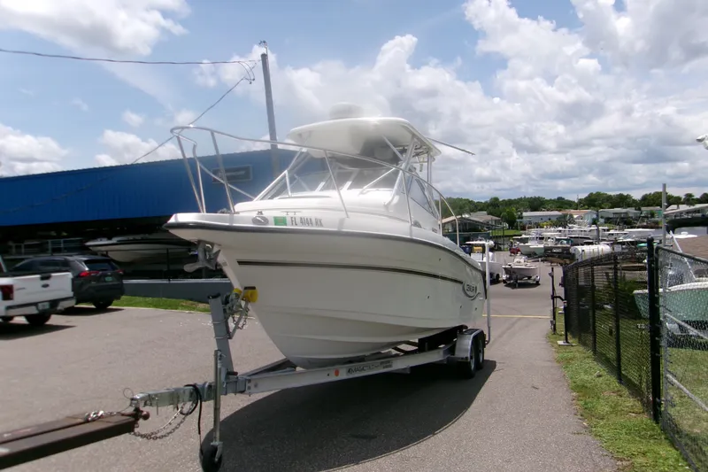 Slide: The Image of 2007 Century 2400 Walk-Around boat on trailer at marina under cloudy sky. - 3