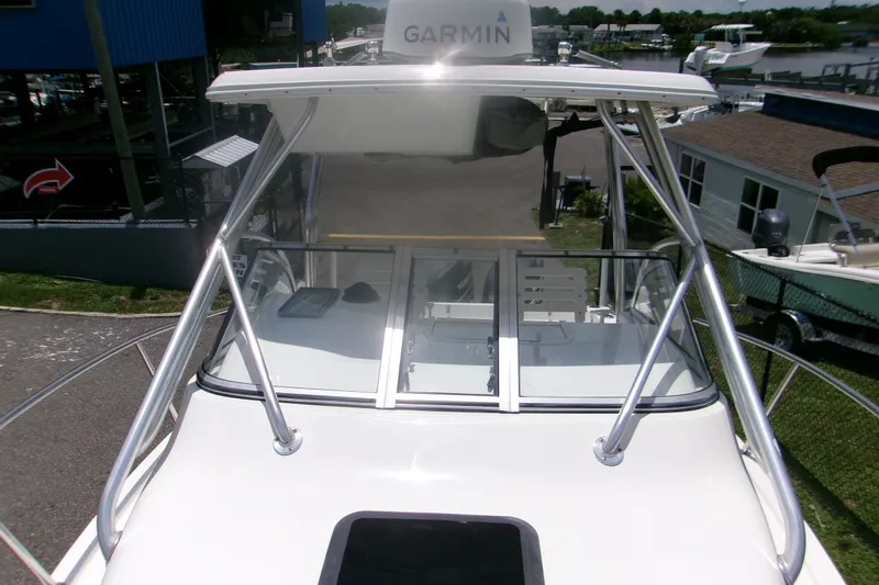 Slide: The Image of 2007 Century 2400 Walk-Around boat with Garmin equipment, docked at a marina. - 13