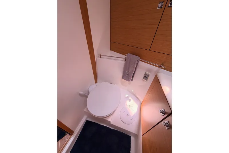 Slide: The Image of Bathroom interior of 2009 Jeanneau Sun Odyssey 45 DS yacht, featuring modern fixtures and wood cabinetry. - 72