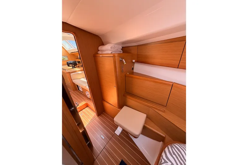 Slide: The Image of Interior of 2009 Jeanneau Sun Odyssey 45 DS yacht, featuring wooden cabinetry and seating. - 74