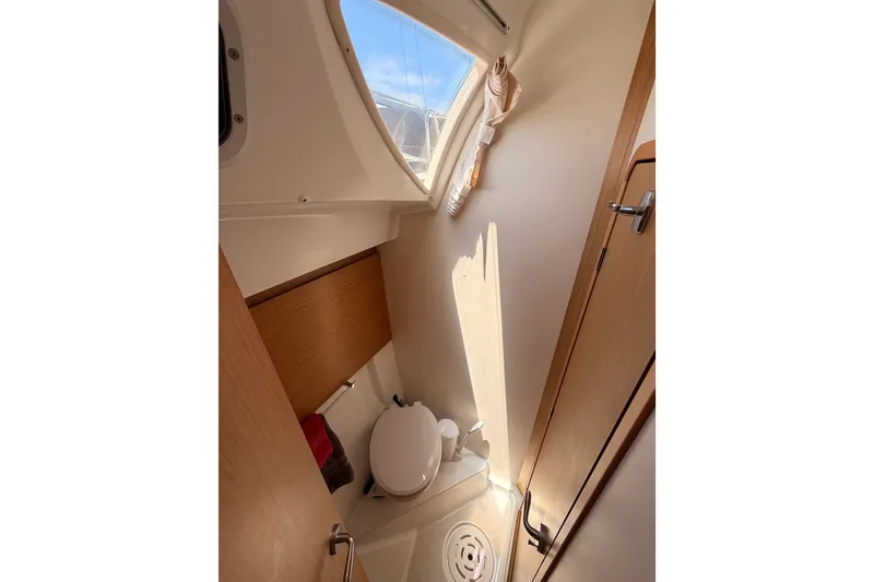 Slide: The Image of Compact bathroom in 2009 Jeanneau Sun Odyssey 45 DS sailboat, featuring a toilet and window. - 81