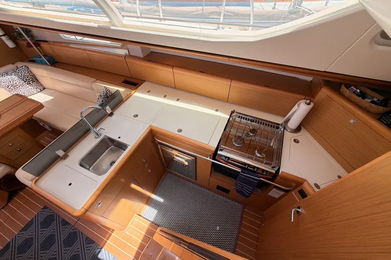 Slide: The Image of Interior of 2009 Jeanneau Sun Odyssey 45 DS yacht, featuring a modern kitchen and seating area. - 43