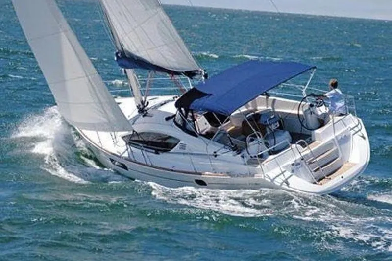 The Image of 2009 Jeanneau Sun Odyssey 45 DS sailing on open sea with blue canopy. - 1