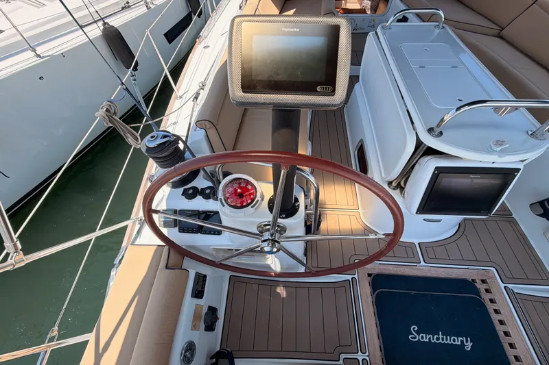 Slide: The Image of Cockpit of 2009 Jeanneau Sun Odyssey 45 DS sailboat with navigation equipment and wooden steering wheel. - 20