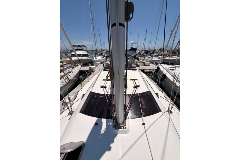 Slide: The Image of 2009 Jeanneau Sun Odyssey 45 DS sailboat docked in a marina, surrounded by other boats. - 35