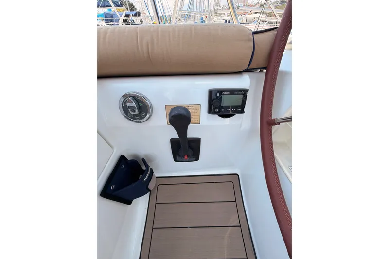 Slide: The Image of Cockpit controls of 2009 Jeanneau Sun Odyssey 45 DS sailboat, featuring steering wheel and navigation instruments. - 21